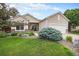 Beautiful home with a lush lawn and stone details leading to a welcoming front porch and attached garage at 21062 Hawthorne Ln, Parker, CO 80138