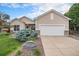 Inviting home exterior showcases a manicured lawn, stylish stone accents, and an attached two-car garage at 21062 Hawthorne Ln, Parker, CO 80138