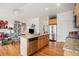 Well-equipped kitchen features an island with a sink and dishwasher, flowing into a living space with stylish seating at 21062 Hawthorne Ln, Parker, CO 80138