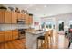 Modern kitchen features granite countertops, wood cabinets, stainless steel appliances, and an island with bar seating at 21062 Hawthorne Ln, Parker, CO 80138