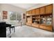 Spacious living room with built-in shelving, a piano, and a large window providing ample natural light at 21062 Hawthorne Ln, Parker, CO 80138