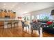 Open-concept living room and kitchen area with hardwood floors and comfortable seating at 21062 Hawthorne Ln, Parker, CO 80138