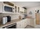 Close up of the wet bar area with stainless steel microwave and sink at 21062 Hawthorne Ln, Parker, CO 80138