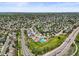 Expansive aerial view showcases a residential area with a community pool, roads, houses, and green spaces at 5694 S Pagosa Ct, Centennial, CO 80015