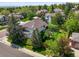 Aerial view of the home showcasing lush landscaping, a well-manicured lawn, and the surrounding neighborhood at 5694 S Pagosa Ct, Centennial, CO 80015