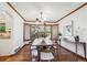 Elegant dining room with hardwood floors, stylish lighting, and a large window at 5694 S Pagosa Ct, Centennial, CO 80015