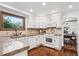 Cozy kitchen featuring granite countertops, stainless appliances and ample cabinet space at 5694 S Pagosa Ct, Centennial, CO 80015