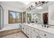 Luxurious bathroom with double vanity, soaking tub, and natural light from large windows at 5694 S Pagosa Ct, Centennial, CO 80015