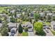Inviting property featuring lush landscaping, mature trees, and a well-maintained lawn, offering a serene suburban setting at 9810 Venneford Ranch Rd, Highlands Ranch, CO 80126