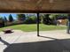 Large, lush backyard with green lawn, framed by mature trees and a wood fence at 9810 Venneford Ranch Rd, Highlands Ranch, CO 80126