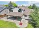 Spacious backyard with a large patio area, perfect for outdoor entertaining and relaxation with mature trees at 9810 Venneford Ranch Rd, Highlands Ranch, CO 80126
