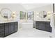 Spa-like bathroom featuring dual vanities, a soaking tub, and bright windows at 9810 Venneford Ranch Rd, Highlands Ranch, CO 80126