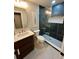 Modern bathroom with stylish vanity, contemporary fixtures, and walk-in shower with decorative tile at 9810 Venneford Ranch Rd, Highlands Ranch, CO 80126