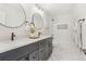 Well-lit bathroom featuring dual sinks, a shower-tub combo, and modern fixtures at 9810 Venneford Ranch Rd, Highlands Ranch, CO 80126