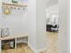 Comfortable entryway with hardwood floors, a bench, and a view of the kitchen at 9810 Venneford Ranch Rd, Highlands Ranch, CO 80126