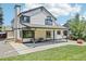The rear exterior of the home with a covered patio overlooking the lawn at 9810 Venneford Ranch Rd, Highlands Ranch, CO 80126
