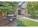 Charming home featuring a welcoming front porch with chairs and a wreath on the front door at 9810 Venneford Ranch Rd, Highlands Ranch, CO 80126