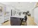Open-concept kitchen showcases a large island, pendant lighting, stainless appliances, and an adjacent living area at 9810 Venneford Ranch Rd, Highlands Ranch, CO 80126