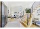 Bright and airy living room featuring a modern staircase with wooden treads and metal railings at 9810 Venneford Ranch Rd, Highlands Ranch, CO 80126