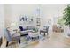 Bright living room boasts soaring ceilings, ample seating, stylish décor, and large windows at 9810 Venneford Ranch Rd, Highlands Ranch, CO 80126