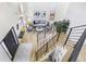 Open-concept living room with high ceilings, modern lighting, and a staircase with metal railings at 9810 Venneford Ranch Rd, Highlands Ranch, CO 80126