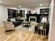 Cozy living room with a fireplace, comfortable seating, and a view of the outdoors through large windows at 9810 Venneford Ranch Rd, Highlands Ranch, CO 80126