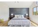 Comfortable bedroom featuring a blue accent wall, stylish lamps and cozy bed at 9810 Venneford Ranch Rd, Highlands Ranch, CO 80126