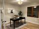 Stylish home office featuring a modern desk, hardwood floors, and natural light from a large window at 9810 Venneford Ranch Rd, Highlands Ranch, CO 80126