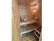 Wooden sauna with two-tiered benches and a sauna heater for relaxation at 9810 Venneford Ranch Rd, Highlands Ranch, CO 80126