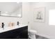 Modern bathroom with a double sink vanity, stylish black fixtures, and contemporary decor at 1390 S Jasmine Way, Denver, CO 80224