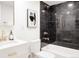 Bathroom featuring a modern vanity, toilet, and a shower with elegant black marble tile at 1390 S Jasmine Way, Denver, CO 80224