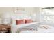 Well-lit bedroom featuring a bed with white bedding, stylish bedside tables, and a view to the outdoors at 1390 S Jasmine Way, Denver, CO 80224