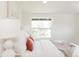 Bright bedroom featuring a comfortable bed with white bedding and natural light from the window at 1390 S Jasmine Way, Denver, CO 80224