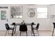 Well-lit dining area featuring a modern table, stylish chairs, and a decorative mirror at 1390 S Jasmine Way, Denver, CO 80224