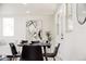 Contemporary dining area with sleek black chairs, modern art, and ample natural light at 1390 S Jasmine Way, Denver, CO 80224