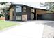 Stylish home exterior showcasing modern design, large windows, and a spacious driveway at 1390 S Jasmine Way, Denver, CO 80224