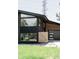 Modern home exterior featuring a unique design, large windows, and landscaped front yard at 1390 S Jasmine Way, Denver, CO 80224