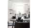 Bright kitchen with white cabinets, marble countertops, and stainless steel appliances at 1390 S Jasmine Way, Denver, CO 80224