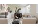 Stylishly decorated living room showcases a neutral color scheme, modern furnishings, and staircase at 1390 S Jasmine Way, Denver, CO 80224