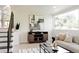 Cozy living room features a comfortable sofa, modern coffee table, media cabinet, and a large window at 1390 S Jasmine Way, Denver, CO 80224