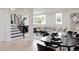 Open concept living room and dining area with black dining table set and minimalist decor at 1390 S Jasmine Way, Denver, CO 80224