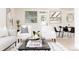 Open living room features modern seating, a coffee table with magazines, and a view of the backyard at 1390 S Jasmine Way, Denver, CO 80224