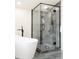 Elegant shower features sleek black fixtures, contrasting tile and glass enclosure at 1390 S Jasmine Way, Denver, CO 80224