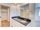 Bathroom featuring dual sinks with a large mirror and modern fixtures at 21242 E 63Rd Dr, Aurora, CO 80019