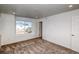 Cozy bedroom with plush carpeting, bright recessed lighting, and a window with neighborhood views at 21242 E 63Rd Dr, Aurora, CO 80019