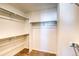 Spacious walk-in closet with shelving and rods providing ample storage solutions at 21242 E 63Rd Dr, Aurora, CO 80019