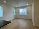 Living room with large window and hardwood floors at 21242 E 63Rd Dr, Aurora, CO 80019