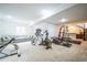 Spacious basement featuring exercise equipment, a lounge area, and a bar, perfect for recreation at 3366 Willow St, Denver, CO 80238