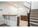 A staircase with carpet and an adjacent basement bar area at 3366 Willow St, Denver, CO 80238