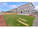 A well-maintained lawn complements the home's exterior with a concrete patio for outdoor living at 2351 Monte Vista St, Fort Lupton, CO 80621